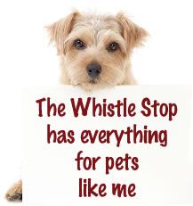 a dog holding a sign that says the whistle stop has everything for pets like me