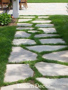 a stone path in the middle of a yard