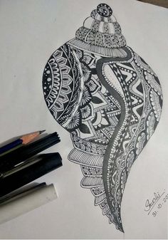 a black and white drawing of an ornament on paper with crayons