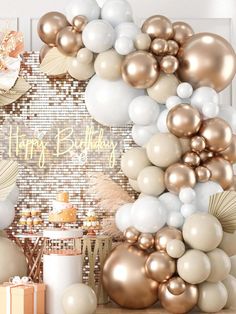 a birthday party with balloons and confetti in gold, white and silver colors