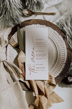 a table setting with napkins, silverware and place settings for an elegant dinner