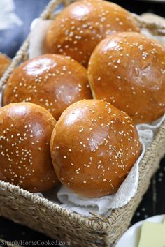 several buns in a basket with sesame seeds on top and the words best brioche buns video