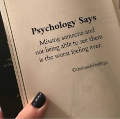 a person is holding up a book with the words, psychology says missing someone and not being able to see them is the worst feeling ever