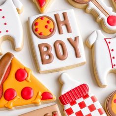 decorated cookies are arranged in the shape of pizzas and hot dogs on a white surface