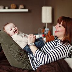 a woman holding a baby on her lap