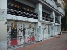 an empty building with graffiti on the windows