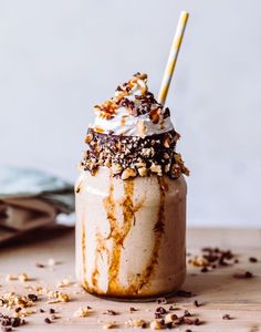 a dessert in a jar with whipped cream and chocolate sprinkles