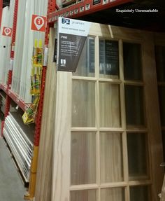 an empty shelf in a store next to other shelves with signs on the front and back