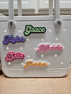 Personalize your beach bags and totes with these retro style font name plates! Fully customizable, you can pick your text, base/background color, and font color! I also offer two different sizes of charms so pick whichever fits the layout of your bag the best! Size simply impacts how large the font and charm is. it does not affect what type or size of bag you can put it on, so just pick whether you would like the charm to look bigger or smaller on your bag! Extremely easy to install! Utilizing a screw and socket system, just insert the charm socket into the desired hole on your bag and screw the custom printed screw into the socket on the charm. This insures a tight fit to your bag so the charm does not fall off or spin when in use! Each charm is 3D printed from a material called PLA. PLA Customizable Green Bags For Personalized Gifts, Personalized Trendy White Bags, Trendy Personalized White Bags, Trendy White Personalized Bags, Customizable Multicolor Bags For Personalized Gifts, Retro White Bags With Letter Print, Retro White Bag With Letter Print, Customizable White Casual Bag, Customizable Casual White Bags