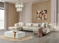 a modern living room with white furniture and wood paneling on the walls, along with a chandelier