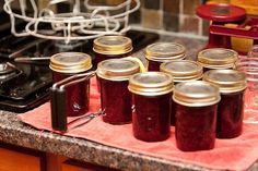 there are many jars on the counter with lids