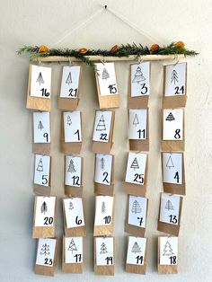 a bulletin board with numbers and trees on it hanging from the wall in front of a white wall