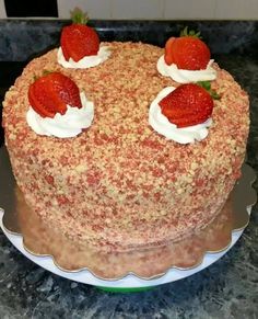 a cake with strawberries and whipped cream on top