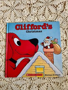 a children's book with a red dog and santa clause on the front cover