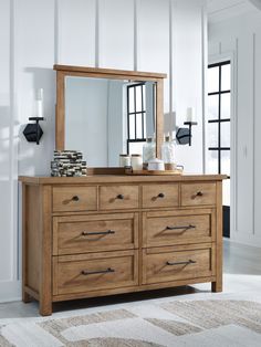 a wooden dresser with a mirror on top of it