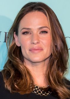 a woman with long hair wearing a black top and leopard print choker on her neck