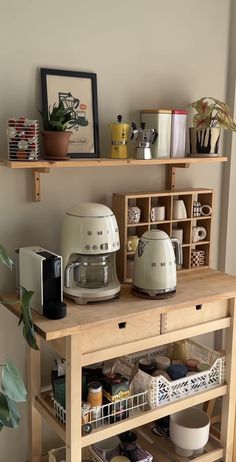 a kitchen island with pots and pans on the top, next to a coffee maker