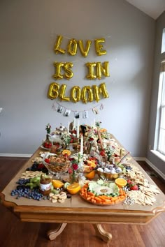 a table topped with lots of food and balloons