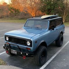 a blue truck parked in a parking lot