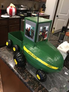 a green toy boat on top of a kitchen counter