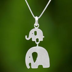 A cute baby elephant accompanies its mother hanging from the neck in this pendant necklace. Jantana of Thailand designs the necklace crafting it from sterling silver with a brushed satin finish to hang from a length of petite box chain. In the pendant the mother elephant hangs from the baby's feet connected like two links in a chain. Mother Elephant, Jewelry Website Design, Two Elephants, Chunky Silver Necklace, Animal Bracelet, Mom And Son, Marcasite Jewelry, Ring Making