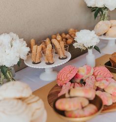 desserts and pastries are displayed on the table