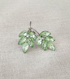 "Pretty pair of leaf earrings featuring mint green crystal rhinestones. I love this shade of pale green! Lightweight and easy to wear. From ear piercing: 1 1/4\" drop (long) x 1/2\" wide. Thanks for stopping by!" Green Leaf Earrings, Cute Green Earrings, Light Green Accessories, Light Green Jewelry, Light Green Shoes, Sage Green Earrings, Quince Jewelry, Green Era, Light Green Earrings