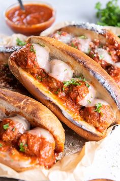 some very tasty looking bread with meatballs on it and sauce in the background