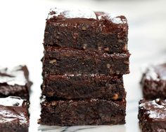 chocolate brownies stacked on top of each other in front of white background with text overlay