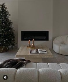 a living room filled with furniture and a christmas tree