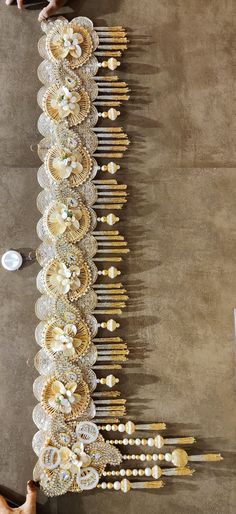 a table topped with lots of gold and white plates