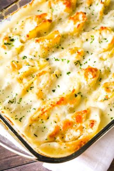 a casserole dish filled with cheese and chicken