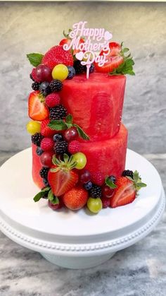 a three tiered cake decorated with fresh fruit