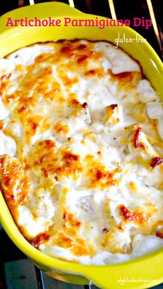 a casserole dish with cheese and sauce in a yellow bowl on a rack