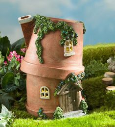 a house made out of clay with plants growing on it