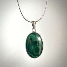 Beautiful and Unique Pendant with genuine Malachite I made it with high quality sterling silver (Ag 925) and beautiful malachite cabochon in shades of green. It is handmade what makes it very special and unique. Malachite's been used as a gemstone / material for sculptures for thousands of years. Nowadays it is quite popular to use it to make jewelry. Malachite is very unique. Each of them have naturally made shades of green going through its surface. Each of cabochons will look different , what makes each ring very individual. There is only one exactly like this so ...  .. If You like it - don't wait too long with a purchase ;)  Information: Shape of Malachite Cabochon: oval Measurements of Malachite: 32 x 20 Whole pendant measurements: Length: 47 [mm]  Width: 23 [mm]  Height/Thickness: 5 Green Polished Sterling Silver Gemstones, Green Sterling Silver Gemstones With Polished Finish, Malachite Pendant, Amber Ring, Silver Jewelry Pendant, Unique Pendant, 925 Silver Jewelry, Jewelry Pendant, Shades Of Green