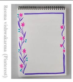 an open notebook with flowers and vines on it