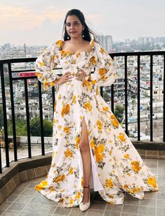 This stunning floral long gown features a vibrant, romantic design perfect for any special occasion. The dress boasts a captivating white base adorned with a beautiful yellow and green floral print, giving it a fresh, summery appeal. The gown's off-shoulder design, complemented by puffed, voluminous sleeves, adds a touch of vintage elegance while accentuating the neckline and shoulders gracefully. The corset-style bodice cinches at the waist, enhancing the silhouette and creating a flattering hourglass shape. The skirt flows effortlessly from the waist down, featuring a high slit that adds a hint of allure and movement to the overall look. The flowing, floor-length hemline ensures a dramatic and eye-catching effect as it gently brushes the ground, making the wearer feel like a modern-day p Wedding Floral Dress, Long Floral Gown, Color Wedding Dress, Wedding Dress Pattern, Wedding Dress Floral, Alternative Wedding Dress, Simple Dress Casual, Wedding Dress Patterns, Off Shoulder Gown