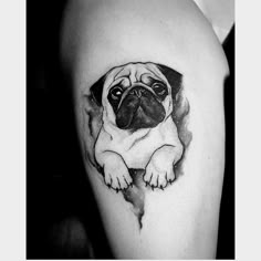 a small pug tattoo on the thigh