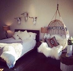 a bedroom with a bed and hanging chair