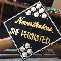 a black and gold graduation cap with white flowers on it that says, never mess she perked