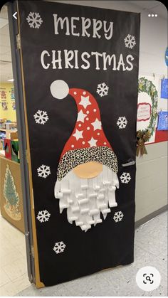 a christmas door decorated with an image of a gnome and snowflakes on it