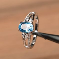 It is a Swiss blue topaz ring. The main stone is 6 mm*8 mm oval cut.weight about 1.47 carats.The basic metal is sterling silver and plated with rhodium.To change the metal to a solid gold (white/rose) or platinum is also available, please ask for a quotation if you want.You can also go to my shop Home for more elegant rings: https://www.etsy.com/shop/godjewelry?ref=hdr_shop_menu Swiss blue topaz is the November birthstone More Swiss blue topaz rings:https://www.etsy.com/shop/godjewelry?search_qu Oval Aquamarine Birthstone Promise Ring, Anniversary Oval Blue Topaz Diamond Ring, Classic Oval Topaz Birthstone Ring, Classic Oval Topaz Ring, Blue Topaz Oval Diamond Ring, Oval Blue Topaz Diamond Ring With Prong Setting, Oval Blue Topaz Diamond Ring, Oval Topaz Promise Ring With Center Stone, Oval Topaz Birthstone Ring With Prong Setting