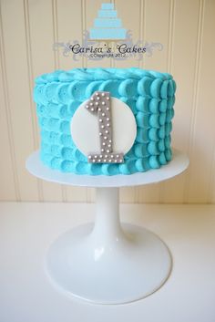 a blue and white cake sitting on top of a table