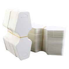 several rolls of white toilet paper stacked on top of each other