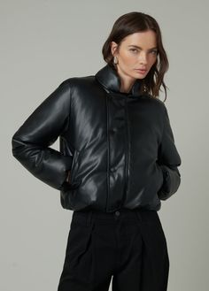 Slightly cropped jacket with a bubble hem that combines traditional styling and puffer detailing. DETAILS + FIT Slightly cropped fit Bubble hem Covered zip & snap closure Elastic hem & sleeve opening Soft vegan leather with added stretch for comfort. 100% Vegan leather with polyester backing Hand wash Turn the jacket inside out to protect the fabric from abrasion. Lay them flat in the sink or bathtub and rinse thoroughly with cold water to remove all suds. Spot clean when needed with a damp clot Puffy Leather Jacket, Cropped Leather Jacket For Winter Streetwear, Fitted Cropped Jacket With Padded Collar, Cropped Puffer Outerwear For Fall, Black Cropped Outerwear With Button Closure, Winter Cropped Jacket With Button Closure, Fall Cropped Puffer Outerwear, Cropped Quilted Outerwear For Fall, Chic Cropped Jacket With Padded Collar