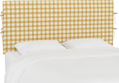 an upholstered headboard with yellow and white checkered fabric