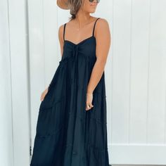 Maxi Dress Tiered, The Material Is So Soft And Flowy, It Feels Like You Are Wearing A Big Piece Of Silk. The Dress Is More Tailored Around The Neck And Chest Area To Define And Add Structure. The Dress Is Available In Black And Navy Blue. Black Cotton Maxi Dress For Vacation, Flowy Black Sundress For Vacation, Black Flowy Sundress In Casual Style, Casual Black Maxi Dress For Brunch, Black Maxi Summer Sundress, Black Maxi Sundress For Summer, Black Summer Midi Dress For Brunch, Black Cotton Sundress Maxi Dress, Black Cotton Vacation Dress