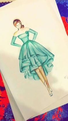 a drawing of a woman in a green dress on top of a piece of paper