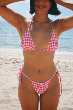 The Baby Doll Bikini Top features our signature triangle top design with the sweetest gingham printed fabric and adorable bow accents. With thin ties and a supportive structure, this bikini top will be your go-to all Summer long. This style is available in red and pink. Handmade Model wearing size Small Pink Bikinis, Shopping Clothes, Red Gingham, Swim Skirt, Gingham Print, Triangle Top, Top Design, One Piece Dress, Costume Dress